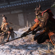 A warrior with a mechanical arm faces off against an enemy in armor in Sekiro: Shadows Die Twice on PS4.